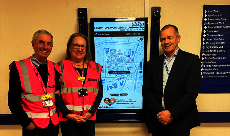 Volunteers at Warwick Hospital celebrating the launch of the Living Map digital wayfinding kiosk.